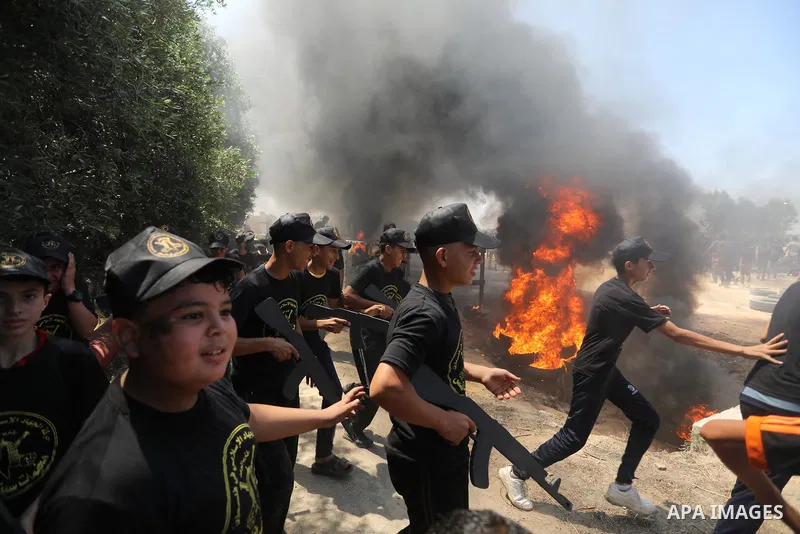 Young Palestinians attend a military summer camp organised by the Islamic Jihad Movement, in Gaza City, June 26, 2021. Photo by Ashraf Amra