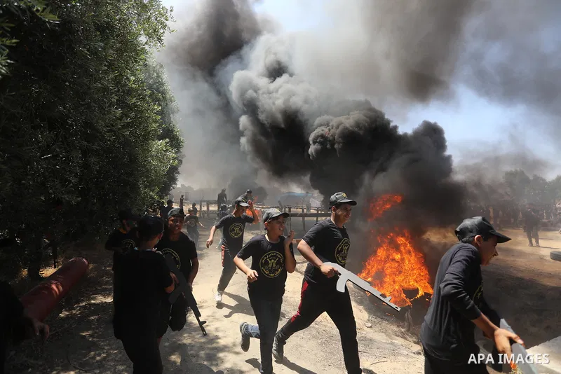 Young Palestinians attend a military summer camp organised by the Islamic Jihad Movement, in Gaza City, June 26, 2021. Photo by Ashraf Amra