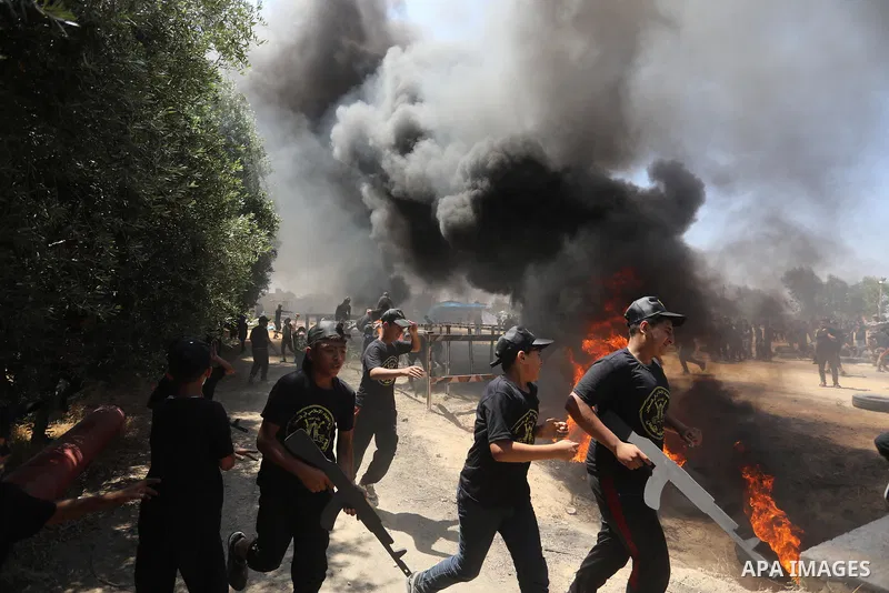 Young Palestinians attend a military summer camp organised by the Islamic Jihad Movement, in Gaza City, June 26, 2021. Photo by Ashraf Amra