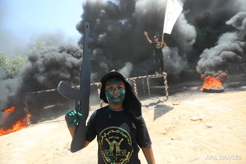 Young Palestinians attend a military summer camp organised by the Islamic Jihad Movement, in Gaza City, June 26, 2021. Photo by Ashraf Amra
