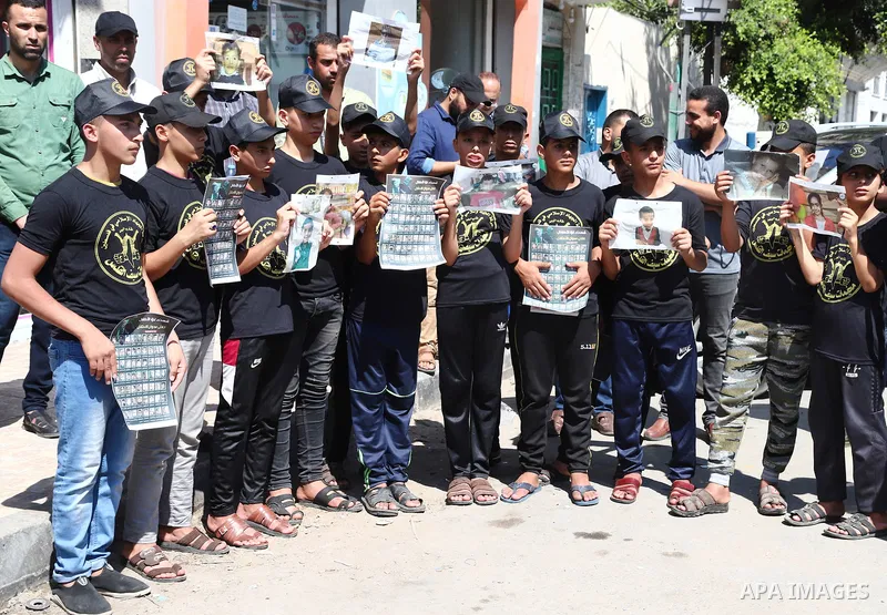 Palestinian youths attend a press conference to announc the summer camps organised by the Islamic Jihad Movement, in Gaza city, on July 26, 2021. Photo by Naaman Omar