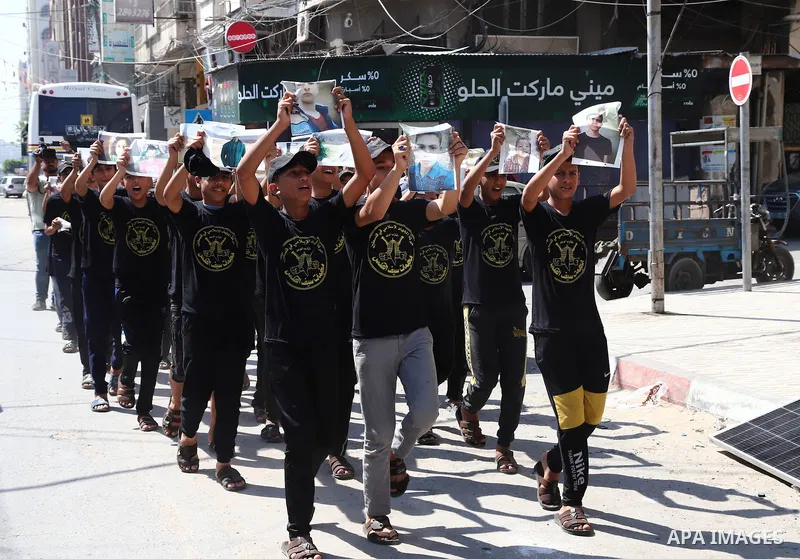 Palestinian youths attend a press conference to announc the summer camps organised by the Islamic Jihad Movement, in Gaza city, on July 26, 2021. Photo by Naaman Omar