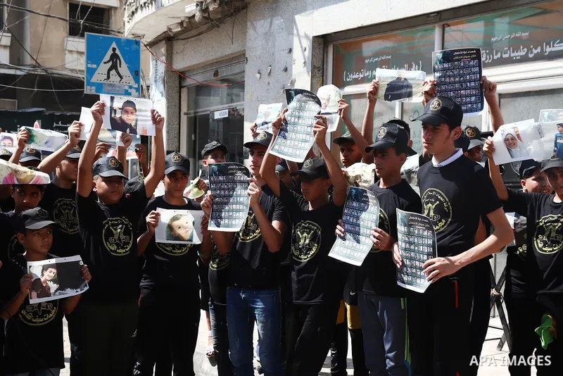 Palestinian youths attend a press conference to announc the summer camps organised by the Islamic Jihad Movement, in Gaza city, on July 26, 2021. Photo by Naaman Omar