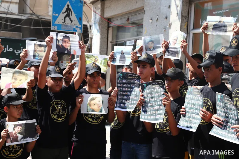 Palestinian youths attend a press conference to announc the summer camps organised by the Islamic Jihad Movement, in Gaza city, on July 26, 2021. Photo by Naaman Omar