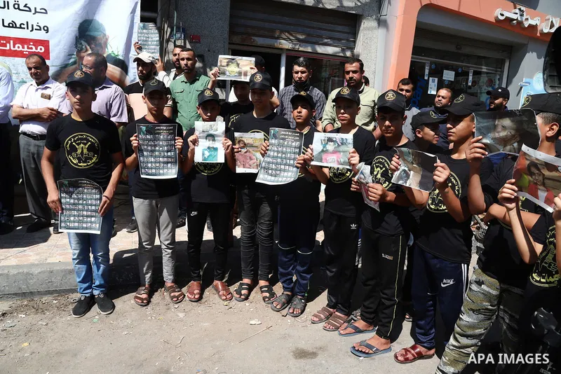 Palestinian youths attend a press conference to announc the summer camps organised by the Islamic Jihad Movement, in Gaza city, on July 26, 2021. Photo by Naaman Omar