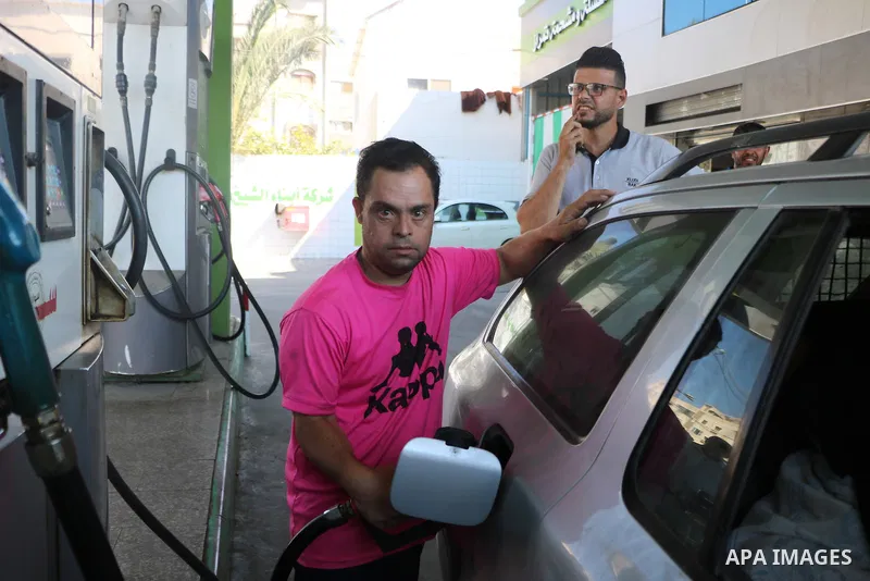 Palestinian, Mohammed Mansour, 30, with Down's Syndrome, works at a gas station, in Rafah in the southern of Gaza strip, on June 26, 2021. Mansour has been working in the station to support his family. Down syndrome or D...