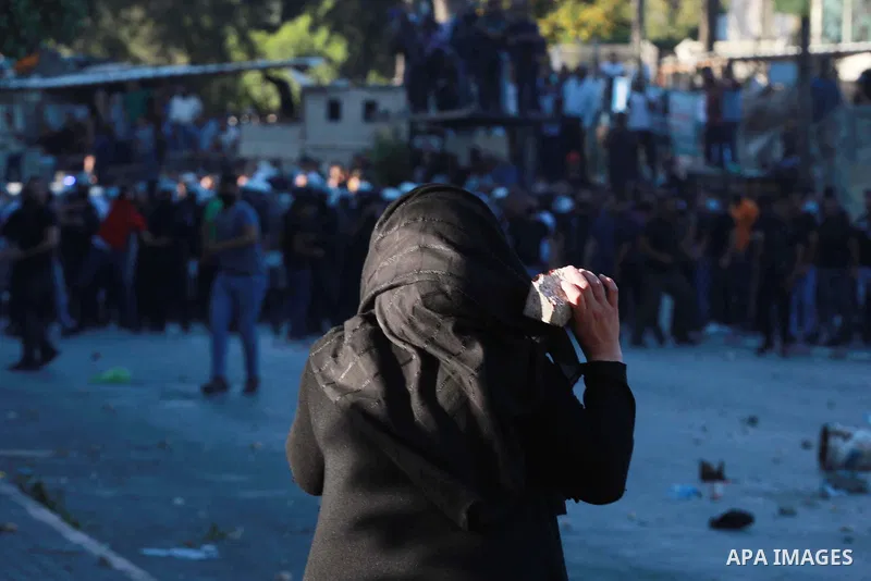 Palestinian protesters clash with Palestinian security forces in the city of Ramallah in the occupied West Bank, on June 26, 2021, following a demonstration against the death of human rights activist Nizar Banat while in...