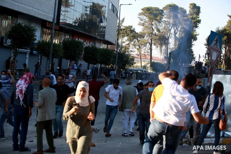 Palestinian protesters clash with Palestinian security forces in the city of Ramallah in the occupied West Bank, on June 26, 2021, following a demonstration against the death of human rights activist Nizar Banat while in...