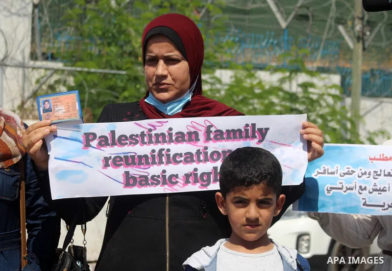 Palestinians hold IDs and banners to demand of the family unification, in front of the headquarter United Nation "UNSCO" in Gaza city, on June 27 2021. Israeli laws and policies prevent the reunification of families betw...