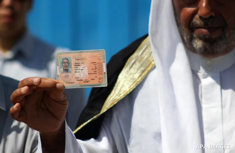 Palestinians hold IDs and banners to demand of the family unification, in front of the headquarter United Nation "UNSCO" in Gaza city, on June 27 2021. Israeli laws and policies prevent the reunification of families betw...
