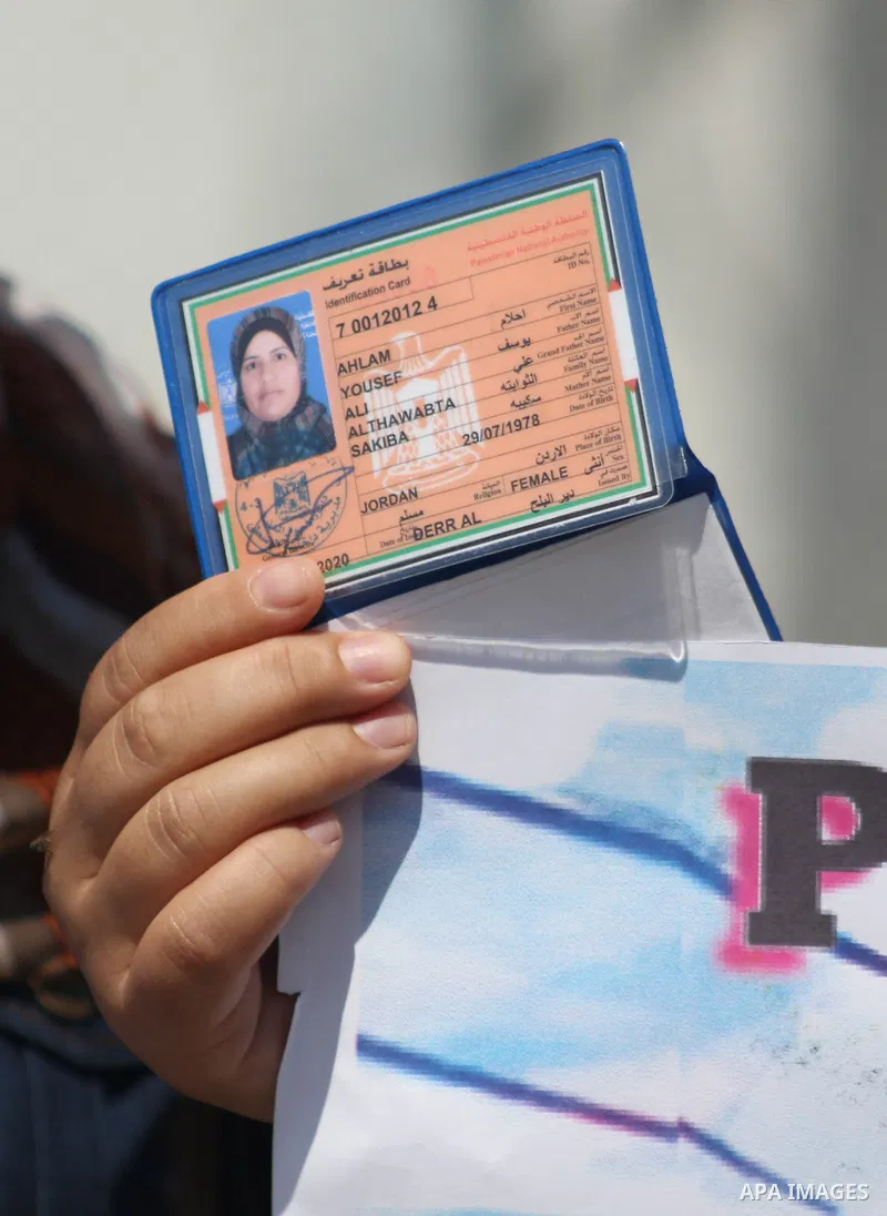 Palestinians hold IDs and banners to demand of the family unification, in front of the headquarter United Nation "UNSCO" in Gaza city, on June 27 2021. Israeli laws and policies prevent the reunification of families betw...