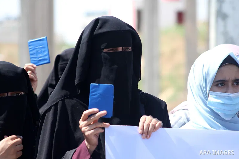 Palestinians hold IDs and banners to demand of the family unification, in front of the headquarter United Nation "UNSCO" in Gaza city, on June 27 2021. Israeli laws and policies prevent the reunification of families betw...