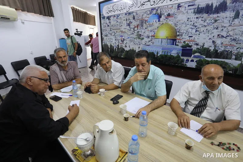 Palestinian members of the National and Islamic forces attend a meeting, in Gaza city, on June 28, 2020. Palestinian group Hamas said Saturday it will not accept any delay in the reconstruction of the Gaza Strip or lifti...