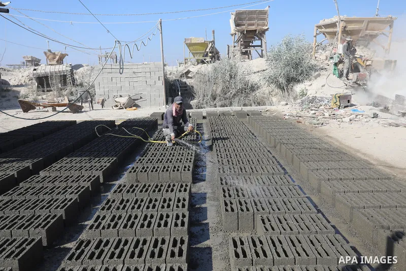 Palestinian workers crush stones and cement blocks from houses destroyed during the recent war on Gaza strip, in Gaza city on June 27, 2021. Owners of houses partially or totally destroyed during the recent war on Gaza a...