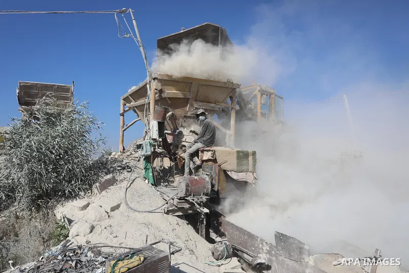 Palestinian workers crush stones and cement blocks from houses destroyed during the recent war on Gaza strip, in Gaza city on June 27, 2021. Owners of houses partially or totally destroyed during the recent war on Gaza a...