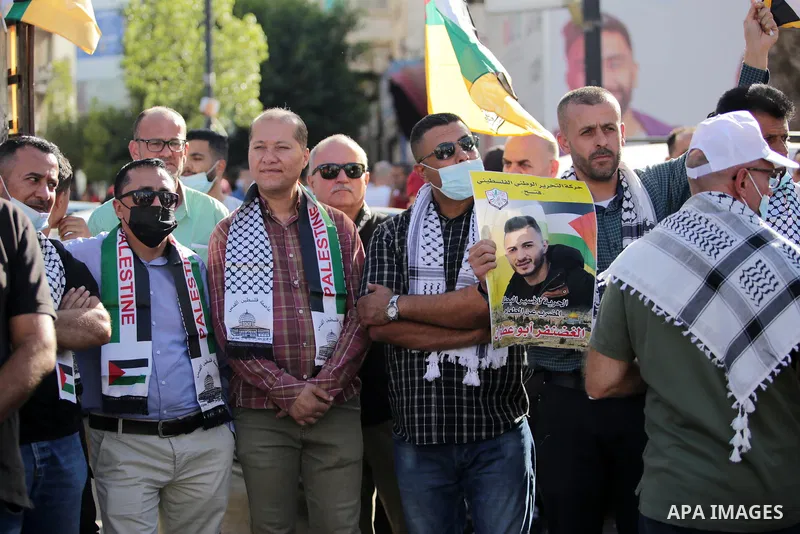 Protesters take part in a protest in solidarity with Palestinian prisoner on hunger strike in Israeli jails, Ghadanfar Abu Utwan, in the West Bank city of Ramallah, on June 27, 2021. Abu Utwan has been on hunger strike f...