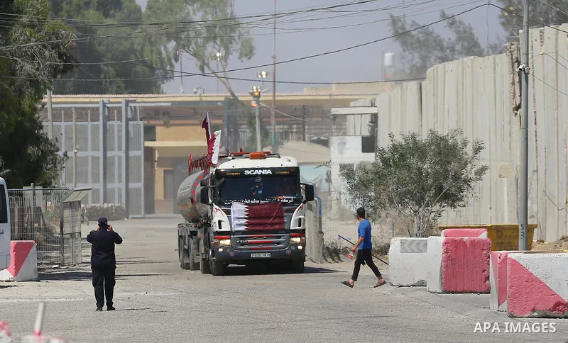 A fuel tanker for Gaza's sole power plant arrives while flying Qatari flags in Rafah in the southern Gaza Strip, on June 28, 2021 Israel allowed fuel tankers funded by Qatar to enter the Gaza Strip via the Kerem Shalom c...