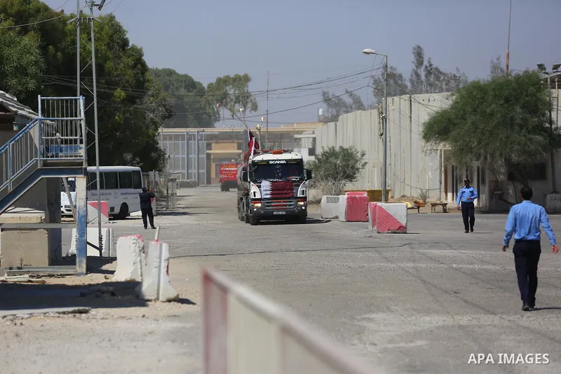 A fuel tanker for Gaza's sole power plant arrives while flying Qatari flags in Rafah in the southern Gaza Strip, on June 28, 2021 Israel allowed fuel tankers funded by Qatar to enter the Gaza Strip via the Kerem Shalom c...