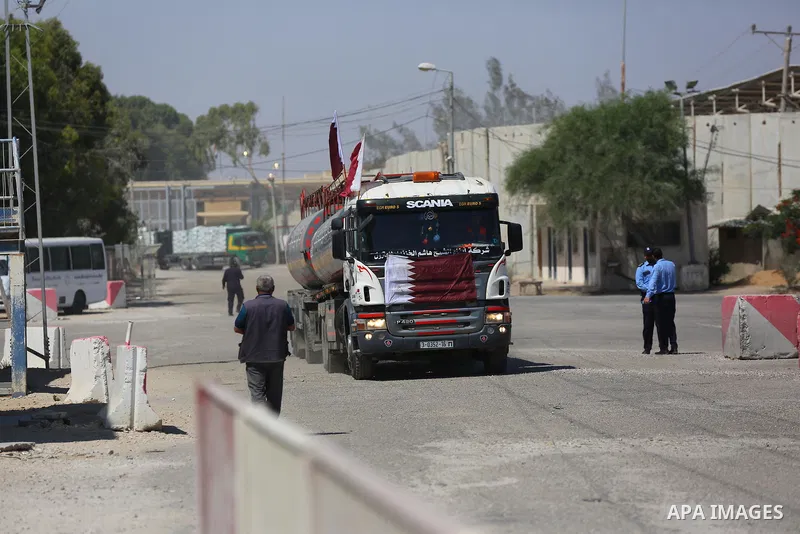 A fuel tanker for Gaza's sole power plant arrives while flying Qatari flags in Rafah in the southern Gaza Strip, on June 28, 2021 Israel allowed fuel tankers funded by Qatar to enter the Gaza Strip via the Kerem Shalom c...