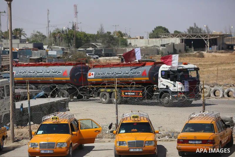 A fuel tanker for Gaza's sole power plant arrives while flying Qatari flags in Rafah in the southern Gaza Strip, on June 28, 2021 Israel allowed fuel tankers funded by Qatar to enter the Gaza Strip via the Kerem Shalom c...