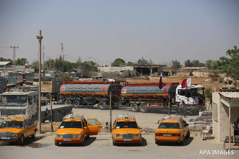 A fuel tanker for Gaza's sole power plant arrives while flying Qatari flags in Rafah in the southern Gaza Strip, on June 28, 2021 Israel allowed fuel tankers funded by Qatar to enter the Gaza Strip via the Kerem Shalom c...
