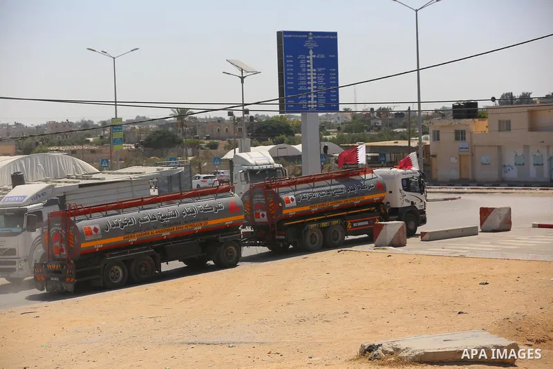 A fuel tanker for Gaza's sole power plant arrives while flying Qatari flags in Rafah in the southern Gaza Strip, on June 28, 2021 Israel allowed fuel tankers funded by Qatar to enter the Gaza Strip via the Kerem Shalom c...