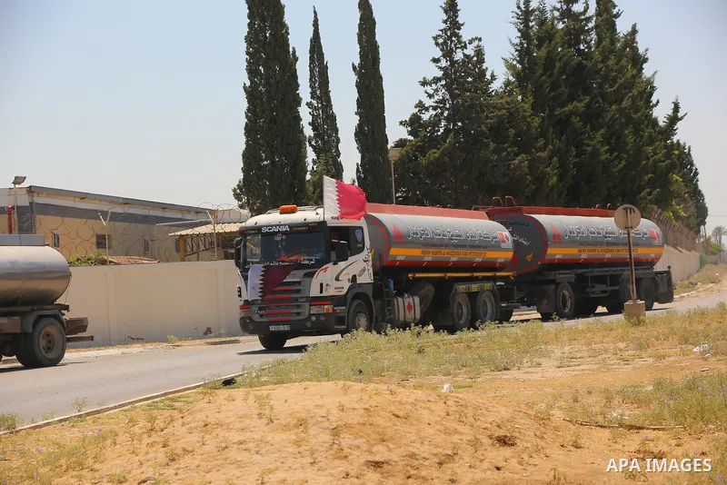 A fuel tanker for Gaza's sole power plant arrives while flying Qatari flags in Rafah in the southern Gaza Strip, on June 28, 2021 Israel allowed fuel tankers funded by Qatar to enter the Gaza Strip via the Kerem Shalom c...
