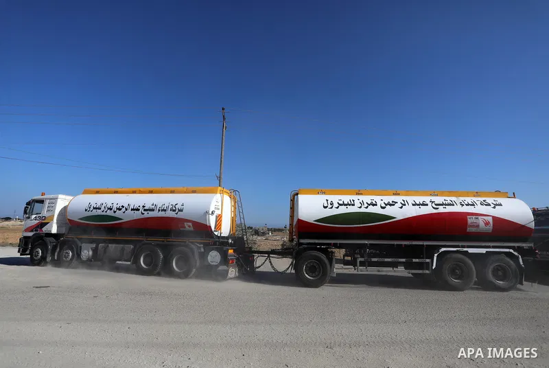 A fuel tanker for Gaza's sole power plant arrives while flying Qatari flags in Rafah in the southern Gaza Strip, on June 28, 2021 Israel allowed fuel tankers funded by Qatar to enter the Gaza Strip via the Kerem Shalom c...
