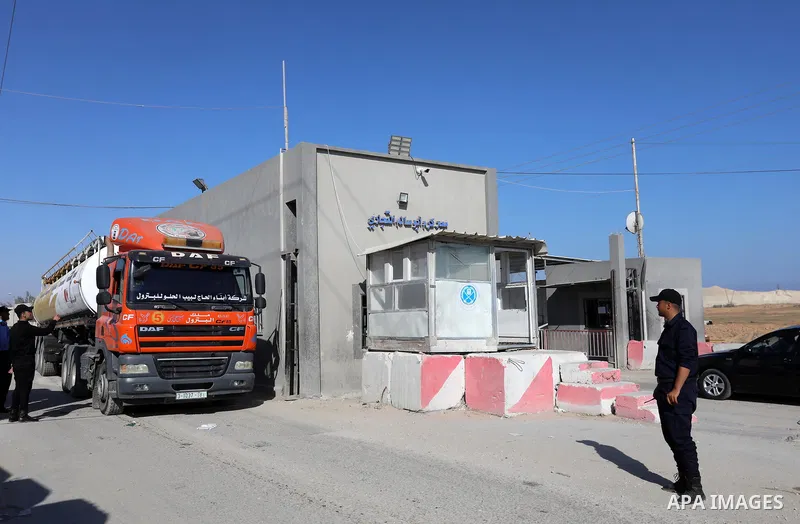 A fuel tanker for Gaza's sole power plant arrives while flying Qatari flags in Rafah in the southern Gaza Strip, on June 28, 2021 Israel allowed fuel tankers funded by Qatar to enter the Gaza Strip via the Kerem Shalom c...