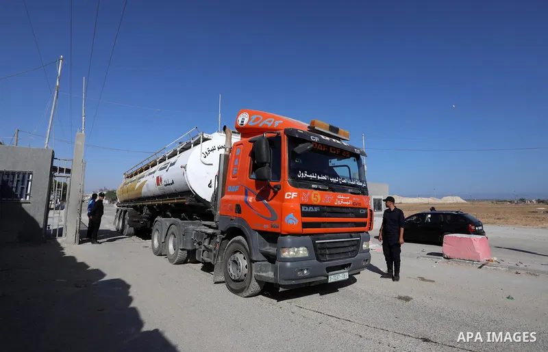 A fuel tanker for Gaza's sole power plant arrives while flying Qatari flags in Rafah in the southern Gaza Strip, on June 28, 2021 Israel allowed fuel tankers funded by Qatar to enter the Gaza Strip via the Kerem Shalom c...