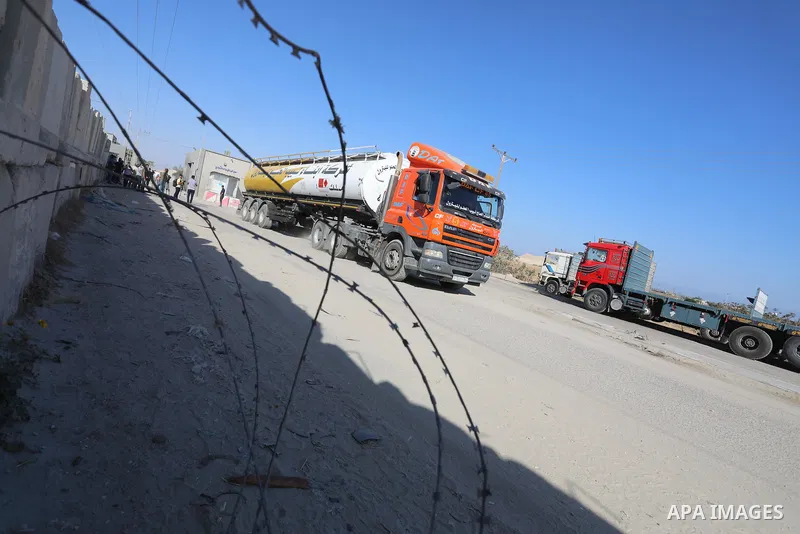 A fuel tanker for Gaza's sole power plant arrives while flying Qatari flags in Rafah in the southern Gaza Strip, on June 28, 2021 Israel allowed fuel tankers funded by Qatar to enter the Gaza Strip via the Kerem Shalom c...