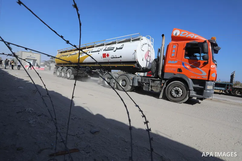 A fuel tanker for Gaza's sole power plant arrives while flying Qatari flags in Rafah in the southern Gaza Strip, on June 28, 2021 Israel allowed fuel tankers funded by Qatar to enter the Gaza Strip via the Kerem Shalom c...