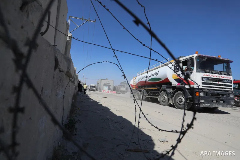 A fuel tanker for Gaza's sole power plant arrives while flying Qatari flags in Rafah in the southern Gaza Strip, on June 28, 2021 Israel allowed fuel tankers funded by Qatar to enter the Gaza Strip via the Kerem Shalom c...
