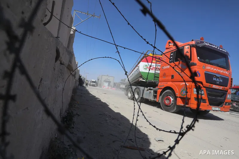 A fuel tanker for Gaza's sole power plant arrives while flying Qatari flags in Rafah in the southern Gaza Strip, on June 28, 2021 Israel allowed fuel tankers funded by Qatar to enter the Gaza Strip via the Kerem Shalom c...