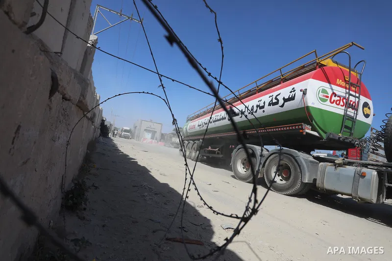 A fuel tanker for Gaza's sole power plant arrives while flying Qatari flags in Rafah in the southern Gaza Strip, on June 28, 2021 Israel allowed fuel tankers funded by Qatar to enter the Gaza Strip via the Kerem Shalom c...