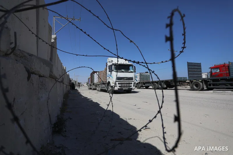 A fuel tanker for Gaza's sole power plant arrives while flying Qatari flags in Rafah in the southern Gaza Strip, on June 28, 2021 Israel allowed fuel tankers funded by Qatar to enter the Gaza Strip via the Kerem Shalom c...
