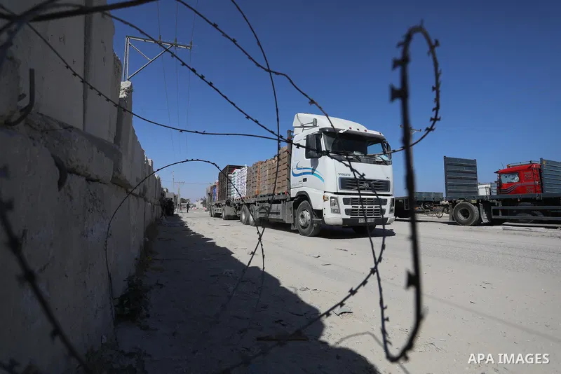 A fuel tanker for Gaza's sole power plant arrives while flying Qatari flags in Rafah in the southern Gaza Strip, on June 28, 2021 Israel allowed fuel tankers funded by Qatar to enter the Gaza Strip via the Kerem Shalom c...