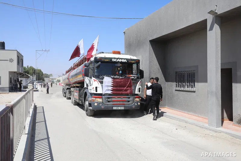 A fuel tanker for Gaza's sole power plant arrives while flying Qatari flags in Rafah in the southern Gaza Strip, on June 28, 2021 Israel allowed fuel tankers funded by Qatar to enter the Gaza Strip via the Kerem Shalom c...