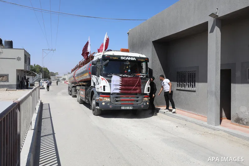 A fuel tanker for Gaza's sole power plant arrives while flying Qatari flags in Rafah in the southern Gaza Strip, on June 28, 2021 Israel allowed fuel tankers funded by Qatar to enter the Gaza Strip via the Kerem Shalom c...