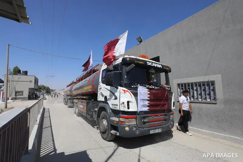 A fuel tanker for Gaza's sole power plant arrives while flying Qatari flags in Rafah in the southern Gaza Strip, on June 28, 2021 Israel allowed fuel tankers funded by Qatar to enter the Gaza Strip via the Kerem Shalom c...