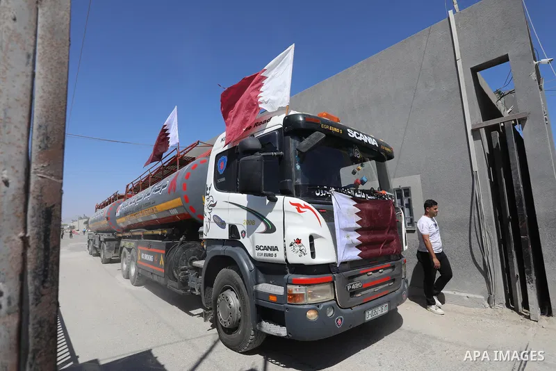A fuel tanker for Gaza's sole power plant arrives while flying Qatari flags in Rafah in the southern Gaza Strip, on June 28, 2021 Israel allowed fuel tankers funded by Qatar to enter the Gaza Strip via the Kerem Shalom c...