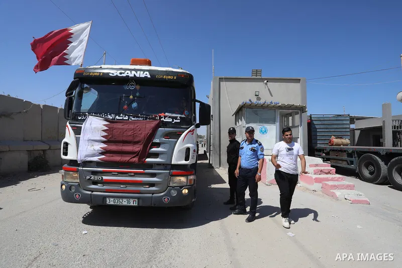 A fuel tanker for Gaza's sole power plant arrives while flying Qatari flags in Rafah in the southern Gaza Strip, on June 28, 2021 Israel allowed fuel tankers funded by Qatar to enter the Gaza Strip via the Kerem Shalom c...