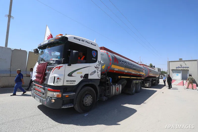 A fuel tanker for Gaza's sole power plant arrives while flying Qatari flags in Rafah in the southern Gaza Strip, on June 28, 2021 Israel allowed fuel tankers funded by Qatar to enter the Gaza Strip via the Kerem Shalom c...