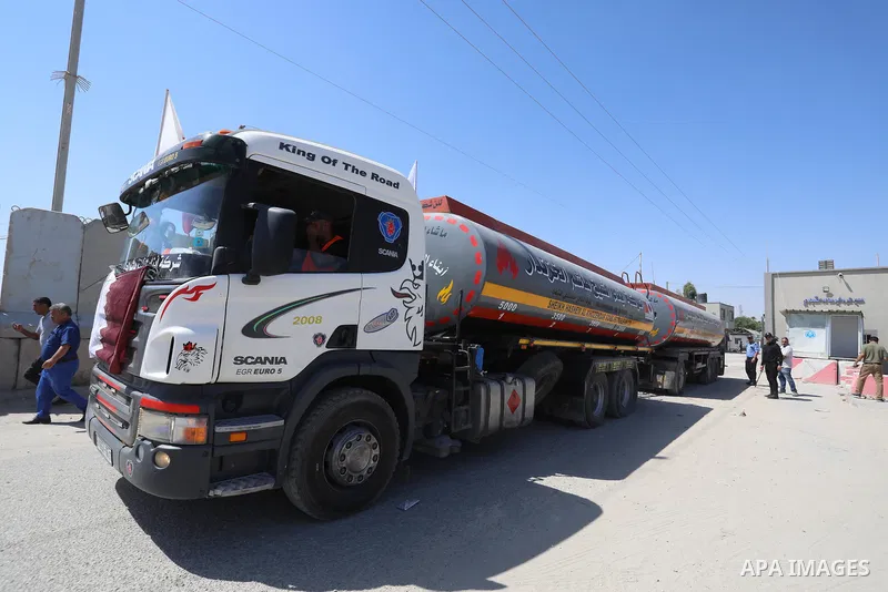 A fuel tanker for Gaza's sole power plant arrives while flying Qatari flags in Rafah in the southern Gaza Strip, on June 28, 2021 Israel allowed fuel tankers funded by Qatar to enter the Gaza Strip via the Kerem Shalom c...