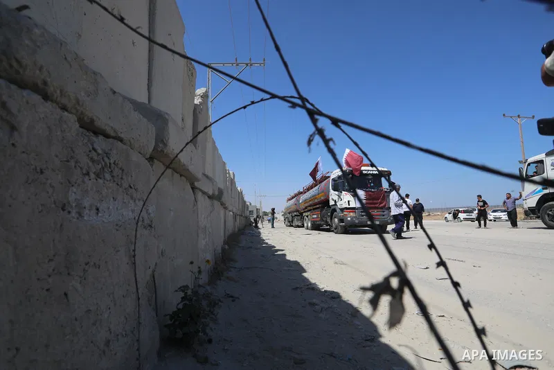 A fuel tanker for Gaza's sole power plant arrives while flying Qatari flags in Rafah in the southern Gaza Strip, on June 28, 2021 Israel allowed fuel tankers funded by Qatar to enter the Gaza Strip via the Kerem Shalom c...