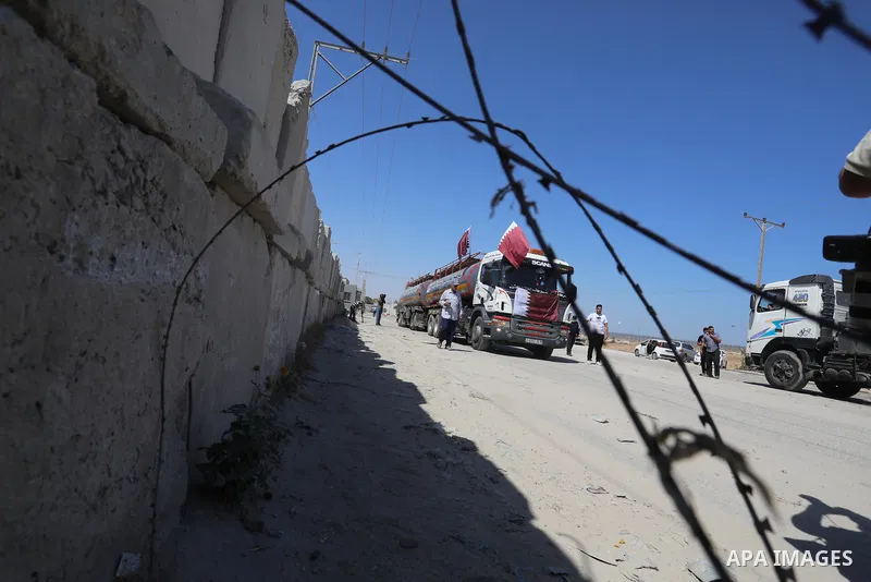 A fuel tanker for Gaza's sole power plant arrives while flying Qatari flags in Rafah in the southern Gaza Strip, on June 28, 2021 Israel allowed fuel tankers funded by Qatar to enter the Gaza Strip via the Kerem Shalom c...