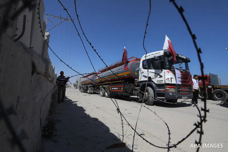 A fuel tanker for Gaza's sole power plant arrives while flying Qatari flags in Rafah in the southern Gaza Strip, on June 28, 2021 Israel allowed fuel tankers funded by Qatar to enter the Gaza Strip via the Kerem Shalom c...