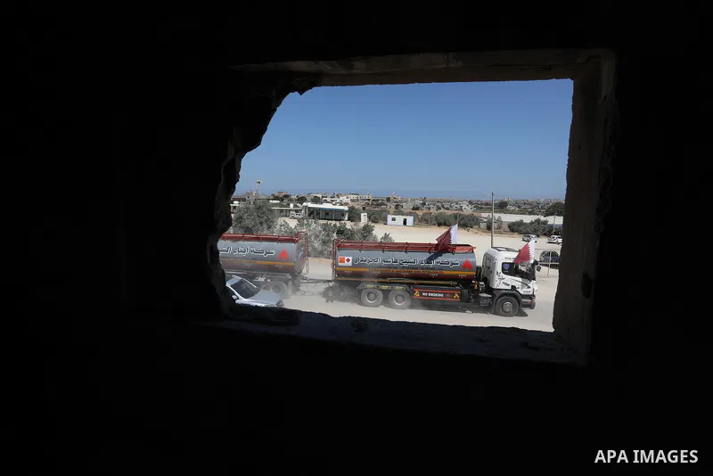 A fuel tanker for Gaza's sole power plant arrives while flying Qatari flags in Rafah in the southern Gaza Strip, on June 28, 2021 Israel allowed fuel tankers funded by Qatar to enter the Gaza Strip via the Kerem Shalom c...