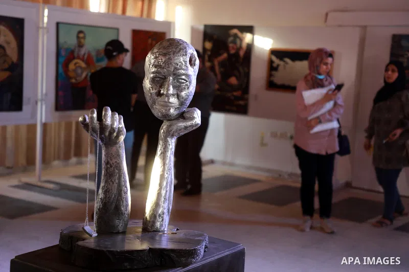 Palestinians attend an exhibition of paintings and sculptures, organized by the Gaza Center for Culture and Arts Association "The Third Gaza Contemporary Visual Arts Festival 2021" in Gaza City, on June 28, 2021. Photo b...