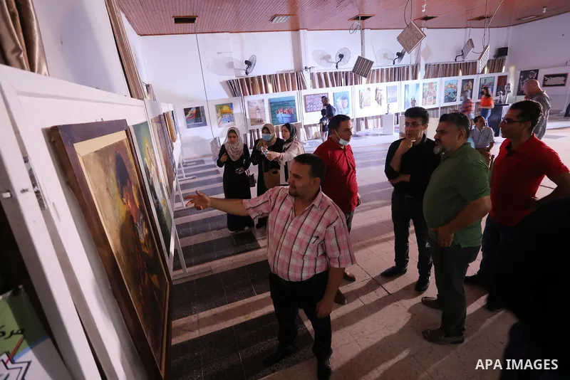 Palestinians attend an exhibition of paintings and sculptures, organized by the Gaza Center for Culture and Arts Association "The Third Gaza Contemporary Visual Arts Festival 2021" in Gaza City, on June 28, 2021. Photo b...